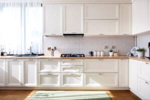 Modern kitchen interior with white Shaker-style wood cabinet doors