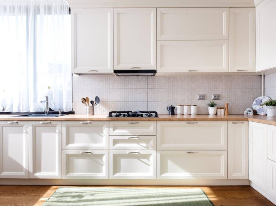 Modern kitchen interior with white Shaker-style wood cabinet doors