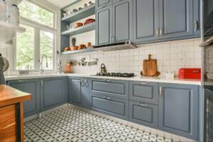 A modern kitchen with blue cabinets.