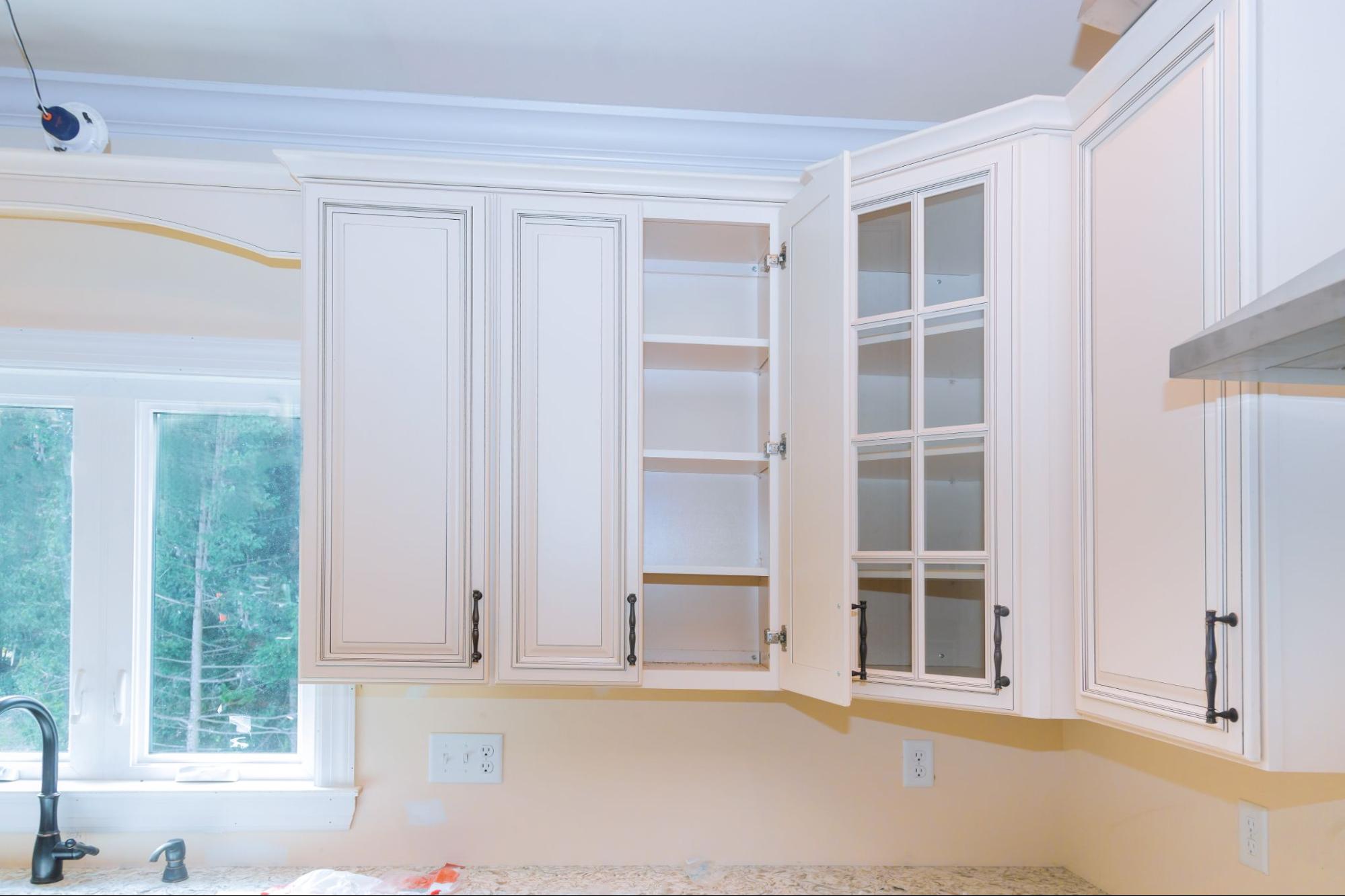 A custom kitchen featuring hanging cabinets with shelves and glass doors, creating a stylish and functional kitchen remodel.