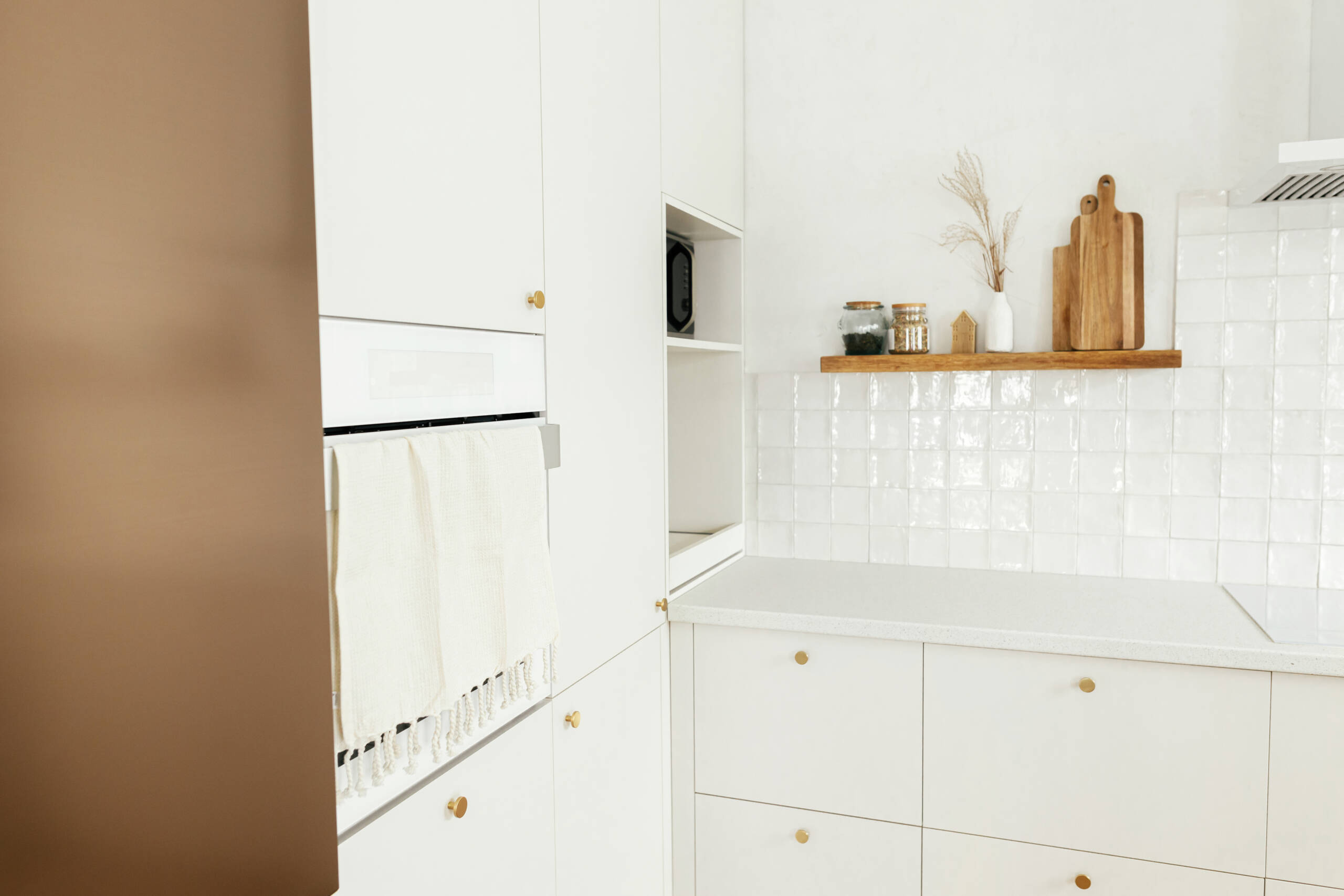 A kitchen with custom cabinetry designs fit with shelving in an out-of-the-way corner.